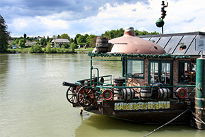 Brauschiff mit Kanone vorne und der gelnem Augschrift Kanonenbräu, rechts der Schriftzug in rot - erstes Brauereischiff Europas